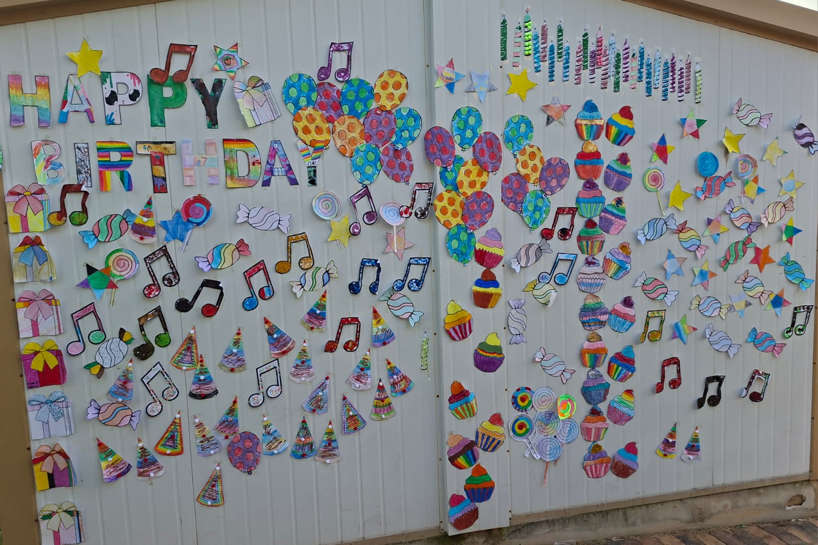 Hand-decorated 'Happy Birthday' artwork wall made by learners